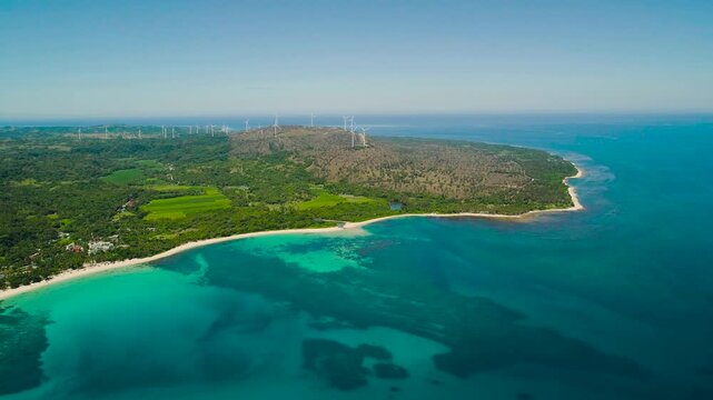 Aerial view of Tropical island with sandy beach by atoll with coral reef and blue sea