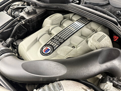 V8 engine of BMW ALPINA E63 Under the bonnet sits a supercharged 4.4-litre V8, delivering 500hp, 516lb-ft of torque. Engine motor of BMW ALPINA E63, E64 B6 with emblem close-up. BMW ALPINA E63, E64. 