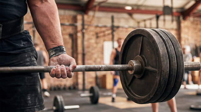 Weightlifting exercise in a gym setting, showcasing strength and fitness. Focus on muscular development and physical endurance.