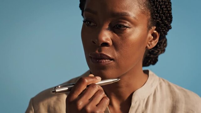 Woman holding lipstick and applying.