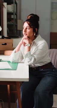 Logistics, stress and thinking with woman in office for delivery, distribution or shipping delay. Anxiety, backlog and problem solving with supply chain person in workplace for warehouse management