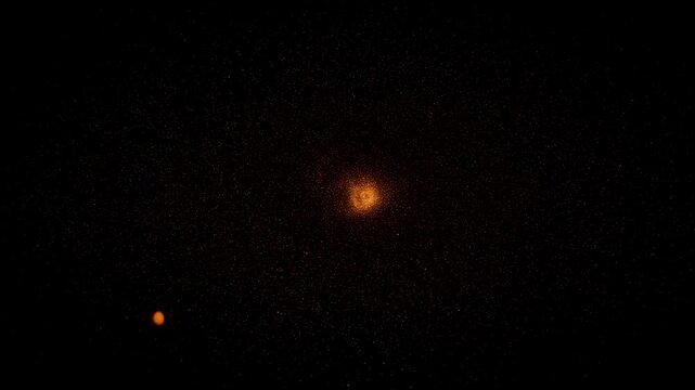 A glowing spiral galaxy-like formation of dense orange and amber particles swirling around a bright luminous core against a pure black void, evoking a cosmic nebula or particle vortex in motion.
