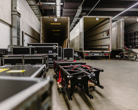 Professional Touring Equipment Cases on Loading Ramp During Event Logistics Setup in Industrial Warehouse Environment