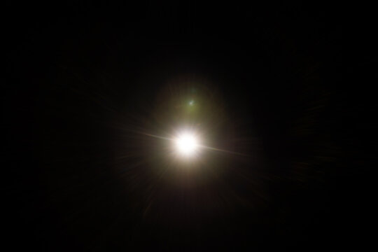 Easy to add lens flare effects for overlay designs or screen blending mode to make high-quality images. Abstract sun burst, digital flare, iridescent glare over black background.