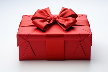 Obraz premium Red gift box wrapped with satin ribbon and bow on a white background