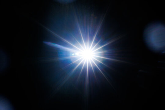 Easy to add lens flare effects for overlay designs or screen blending mode to make high-quality images. Abstract sun burst, digital flare, iridescent glare over black background.