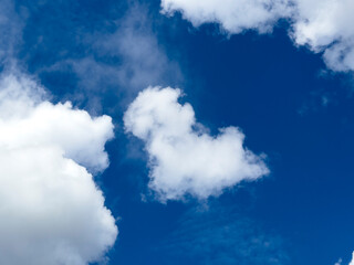 Obraz premium Blue sky with white clouds. Open cloudscape with bright weather background. Nature copy space for travel and design..