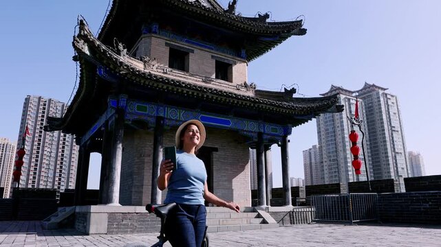 Tourist taking a selfie on the ancient city wall of Xi'an in China