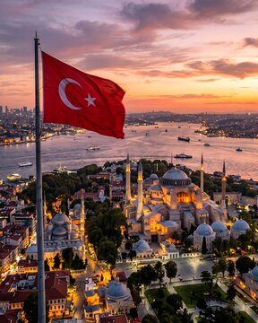 Turkish Flag on Flagpole with Hagia Sophia at Sunset, Aerial Drone View.