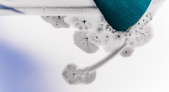 Abstract nature background of frozen lake with ice patterns, winter landscape, copy space.