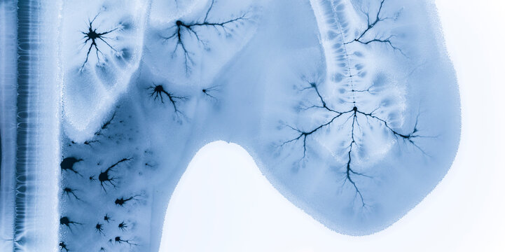 Abstract nature background of frozen lake with ice patterns, winter landscape, copy space, Fusine lakes, Tarvisio, Friuli, Italy.