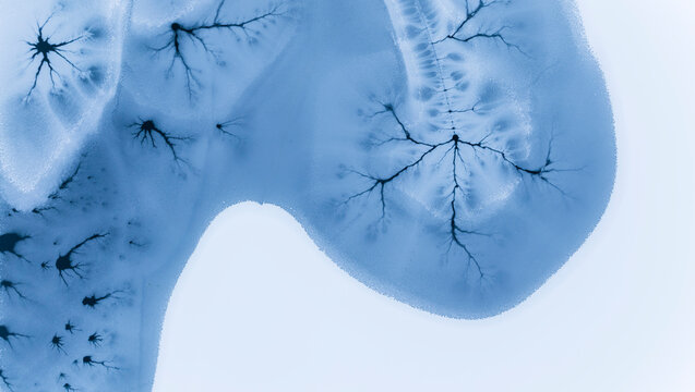 Abstract nature background of frozen lake with ice patterns, winter landscape, copy space, Fusine lakes, Tarvisio, Friuli, Italy.