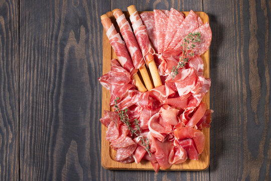 Charcuterie board. Antipasti appetizers of meat platter with salami, prosciutto crudo or jamon and olives.