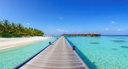 Fototapeta premium Wooden pier extending over turquoise waters and sandy beach under blue sky