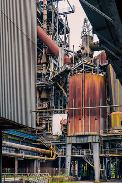 Old industrial factory complex pipes heavy machinery wallpaper background
