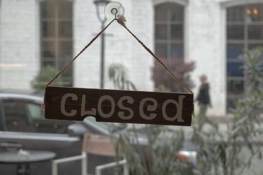 Wooden Closed Sign Hanging on Storefront Window
