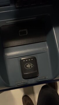 Close up of banking with focus. Secure urban ATM with illuminated keypad and contactless touch. Close view of banking kiosk where user inserts card into automated machine