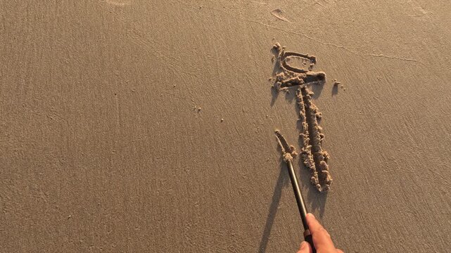 Arabic letters Alif, Baa and Taa written in sandy beach, symbolizing language, education and cultural expression in a peaceful coastal setting with natural light and soft waves.