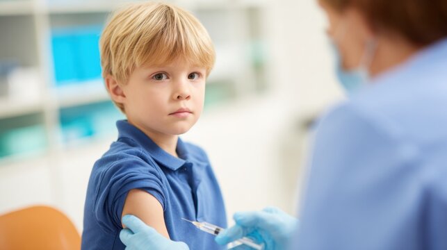 A young boy looks apprehensive as a healthcare professional prepares to administer a vaccine