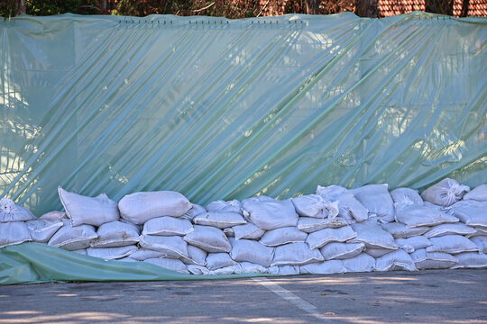 Wall of Sand Bags and Tarp Plastic for City River Water Spring Floods Protection