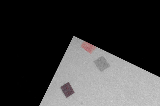 White Paper Texture with Small Colored Squares on Black Background