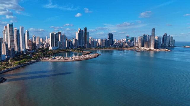 Red-roofed architecture at the picturesque shore surrounded by blue waterscape. Picturesque panorama of Casco Viejo, Panama City, Republic of Panama, North America.
