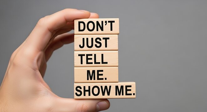 Hand holding motivational Scrabble-style blocks