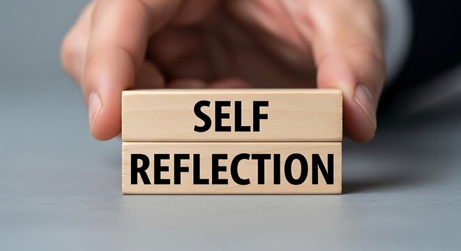 Hand holding self-reflection wooden blocks