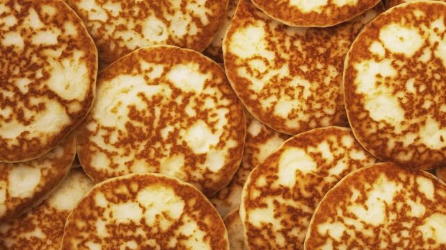 Motion background and texture of a mountain of pancakes. Top view. Fresh homemade pancakes.