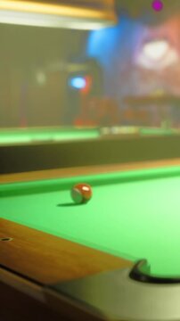 A red ball rolls on a green pool table in a bar. Players can be seen in the background engaged in conversation while enjoying the game.