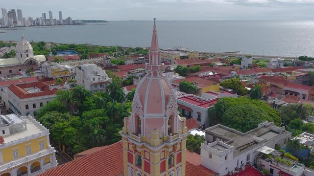Aerial orbit around the Cartagena Cathedral in the historic center of Cartagena, Colombia, with views of the Caribbean Sea and a transition toward the Bocagrande skyline. 