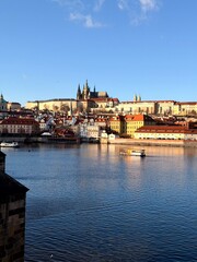 Fototapeta premium Prague Castle and Charles Bridge over Vltava river in sunny cityscape