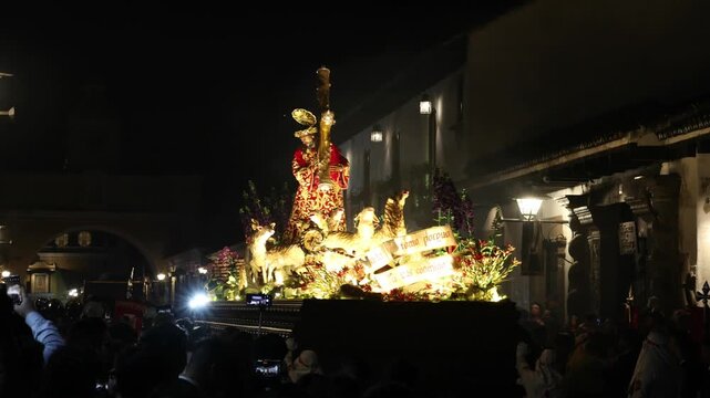 catholic procession at night in antigua guatemala (religious christian devotion display with people lit jesus float)