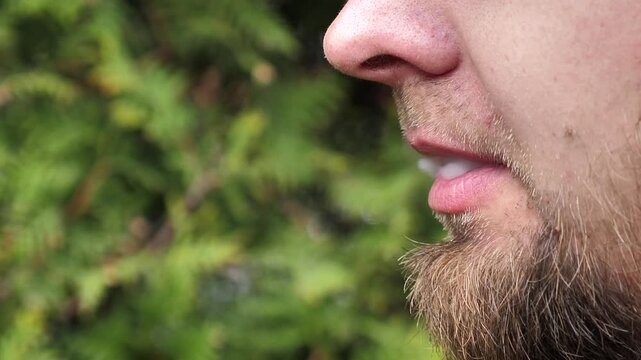 Man smoking an electronic cigarette. Close-up. Space for text.
