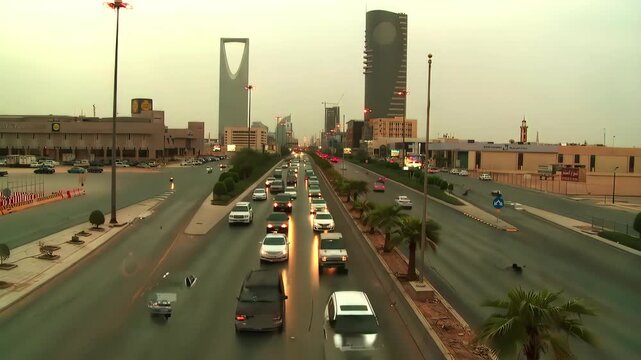 Riyadh City Skyline Aerial View Featuring Kingdom Tower and Heavy Traffic Flow on King Fahd Road, Saudi Arabia.