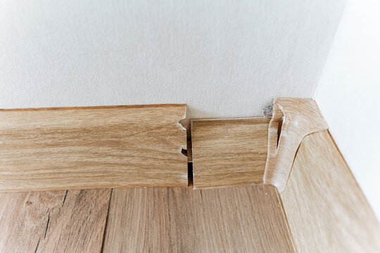 Damaged Trim Revealed. Poorly Installed Skirting Suffering From Multiple Defects. Closeup Documentation Highlights Substantial Flaws In Skirting Installation And Damaged Finishes