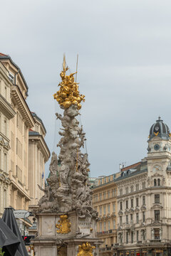 14 April 2026, Vienna (Innere Stadt), Austria. Plague Column with Generali building in historic city street