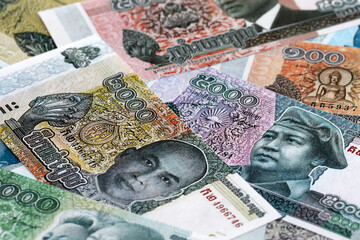 Cambodian riel money banknotes pile on table. Cambodia bills of KHR currency close up © Larysa