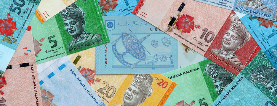 Malaysian ringgit money banknotes pile on table. Malaysia bills of MYR currency close up