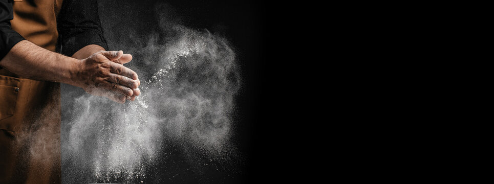 Chef clapping flour creating cinematic powder explosion with large copy space