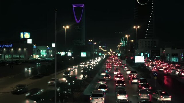 Riyadh City Skyline Aerial View Featuring Kingdom Tower and Heavy Traffic Flow on King Fahd Road, Saudi Arabia.