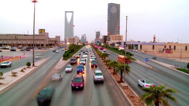 Riyadh City Skyline Aerial View Featuring Kingdom Tower and Heavy Traffic Flow on King Fahd Road, Saudi Arabia.