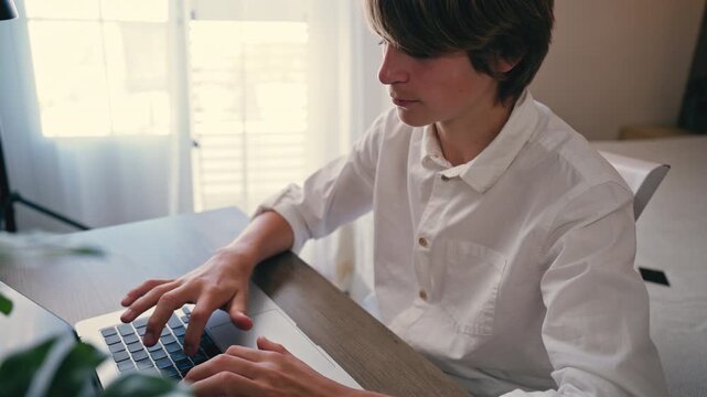 Young student working on laptop, developing digital skills, online learning, education at home and future career concept.