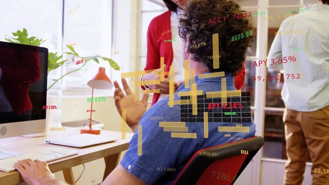 Seated man typing and gesturing while standing woman starting finance chart overlay for APY review