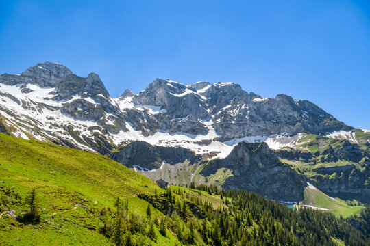 Snow capped Swiss Alps peaks above Bannalpsee