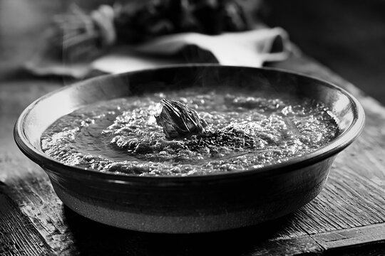 Rustic pappa al pomodoro soup in a ceramic bowl on a wooden table