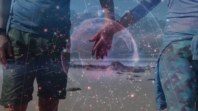 Female reaching toward male on beach, hands closing while sphere over hands showing tech bond