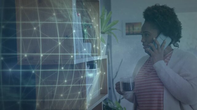 Woman holding mug, talking on phone, call starting tech globe grid shifting pulsing over shelf