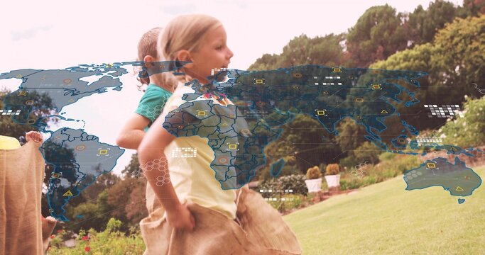 Hopping five children racing in garden wearing T-shirts and shorts, burlap sacks, world map overlay