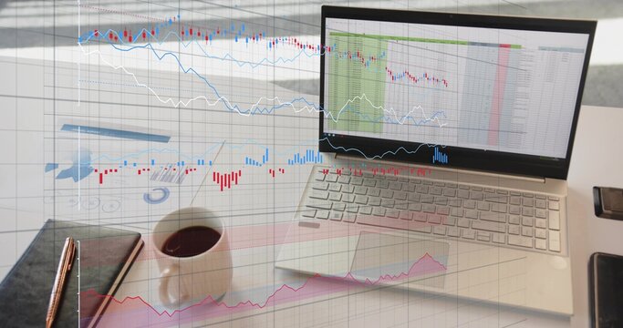 Displaying laptop showing spreadsheets and market overlays in office with notebook, mug, report